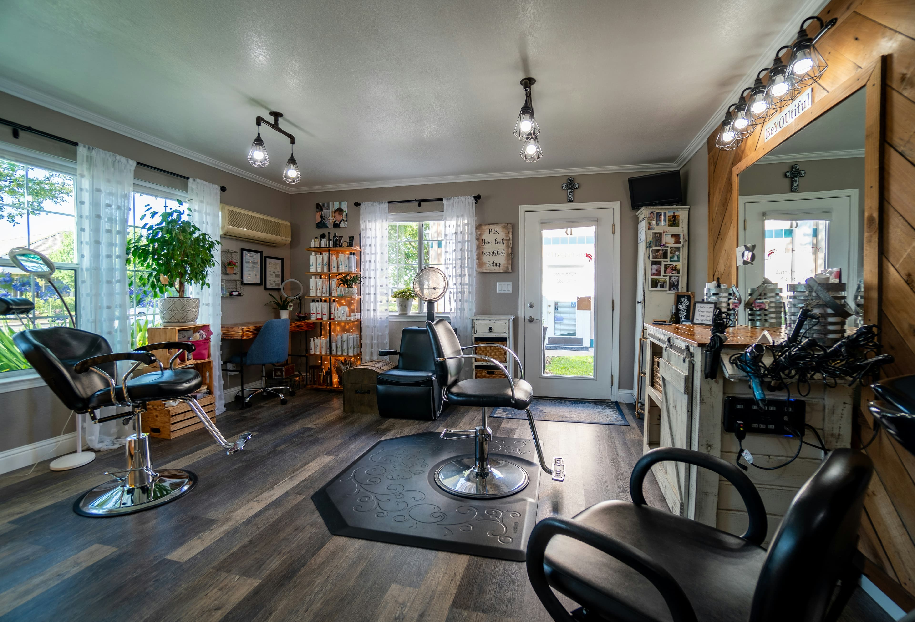 Corporate Kemp Inc beauty salon interior with elegant styling stations and warm lighting
